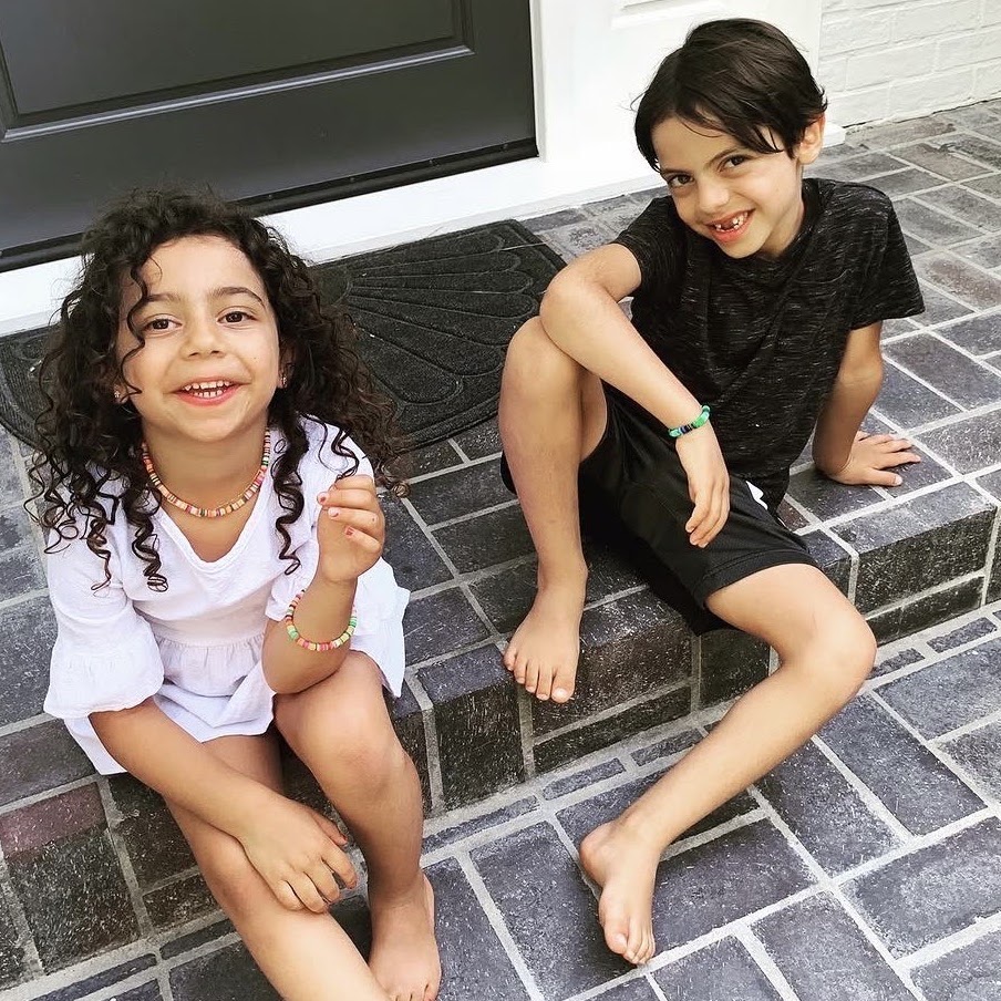 Two children wearing Happy Piece bracelets